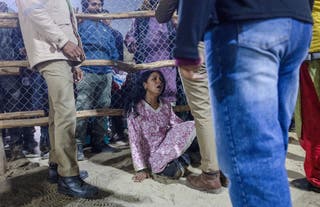 A devotee is seen shocked after a deadly stampede before the royal bath at the Kumbh Mela